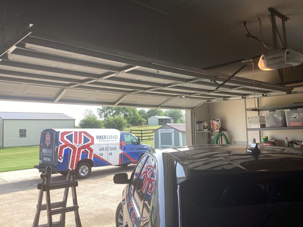 An open garage door with a Riker Garage service van outside, indicating repair or installation work by Riker Home Services in Plano, TX