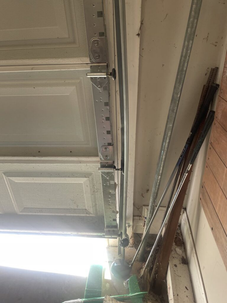 Close-up of garage door rollers and track system, showing maintenance by Overhead Door Company of Columbus in Columbus, GA.