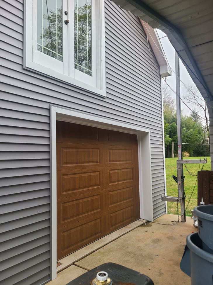 New garage door and gray siding installation by Jos Construction LLC in Trenton, NJ.