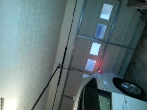 Interior view of a garage showing the springs and track system, indicating repair work by Overhead Door Company of Columbus in Columbus, GA.