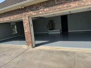 A newly installed epoxy floor in a residential garage by Ricos Renovations in Arlington, TX