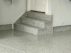 Close-up of a garage floor and steps with a durable epoxy coating by Garage Upgrade Pros in Fort Mill, SC.