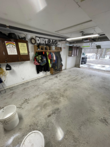 A garage floor before epoxy installation, showing the concrete surface, by Epoxy Evolution in Albany, NY.