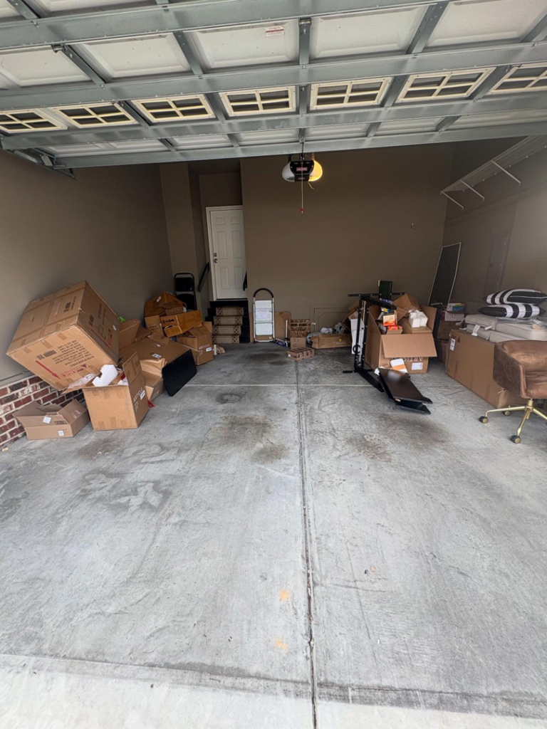 A garage filled with numerous boxes and unwanted items, ready for junk removal by JD Junk Removal in Raleigh, NC.