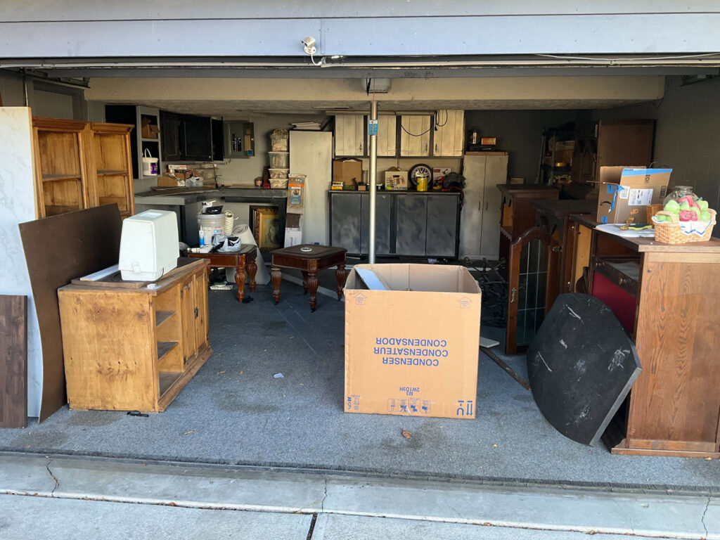 A garage filled with old furniture and boxes, ready for junk removal by Midwest Removal in Omaha, NE.