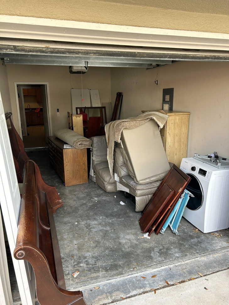 A garage filled with old furniture and household junk ready for removal by Just Dump It in Jacksonville, FL.
