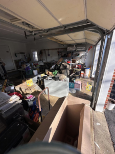A garage overflowing with junk and boxes, ready for cleanup by 302-Rid-Junk in Wilmington, DE.
