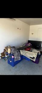 A garage filled with various items and debris ready for removal by The Junkporter Junk Removal in Las Vegas, NV.