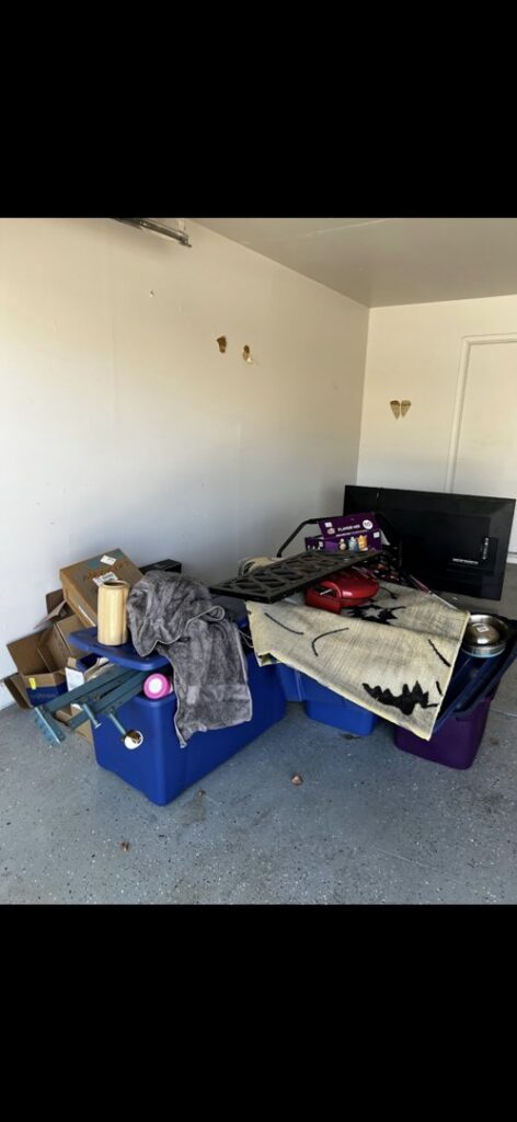 A garage filled with various items and debris ready for removal by The Junkporter Junk Removal in Las Vegas, NV.