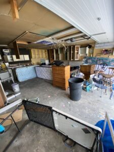 A garage filled with old mattresses, dressers, and various furniture items, awaiting removal by Hudson's Trash Removal, LLC in Great Falls, MT.