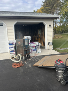 Insulation materials and equipment set up for a garage insulation project by Weathertite Insulation in Oshkosh, WI.