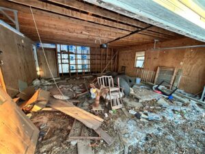 Cluttered garage interior with various junk items for removal by Insta Junk Removal & Demolition LLC in Salisbury, MD