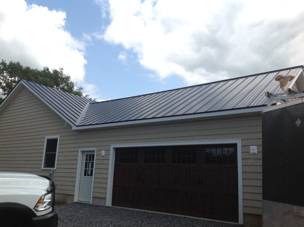 Garage with new metal roof and siding installation by JB Home Improvement Services in Sanford, FL.