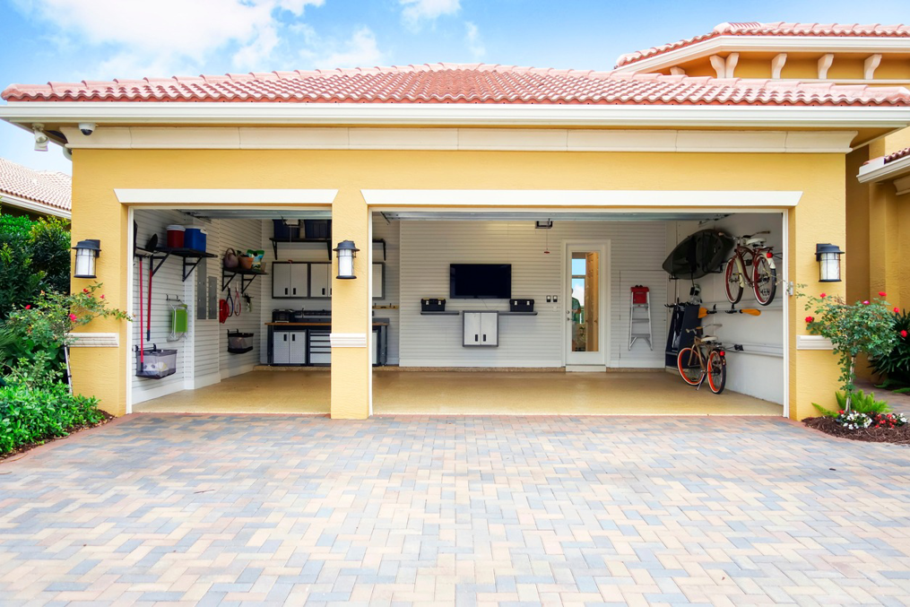 A neatly organized garage with installed shelving and cabinets, showcasing handyman organization services by Kiwi Construction in Knoxville, TN.