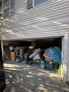 A garage overflowing with various items and junk, ready for removal by Junkjet in Charlotte, NC.