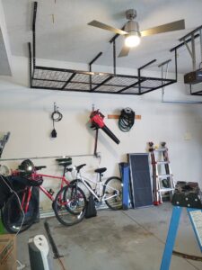 A newly installed overhead storage rack in a garage, a service offered by IFixdIt Handyman Services in Omaha, NE.