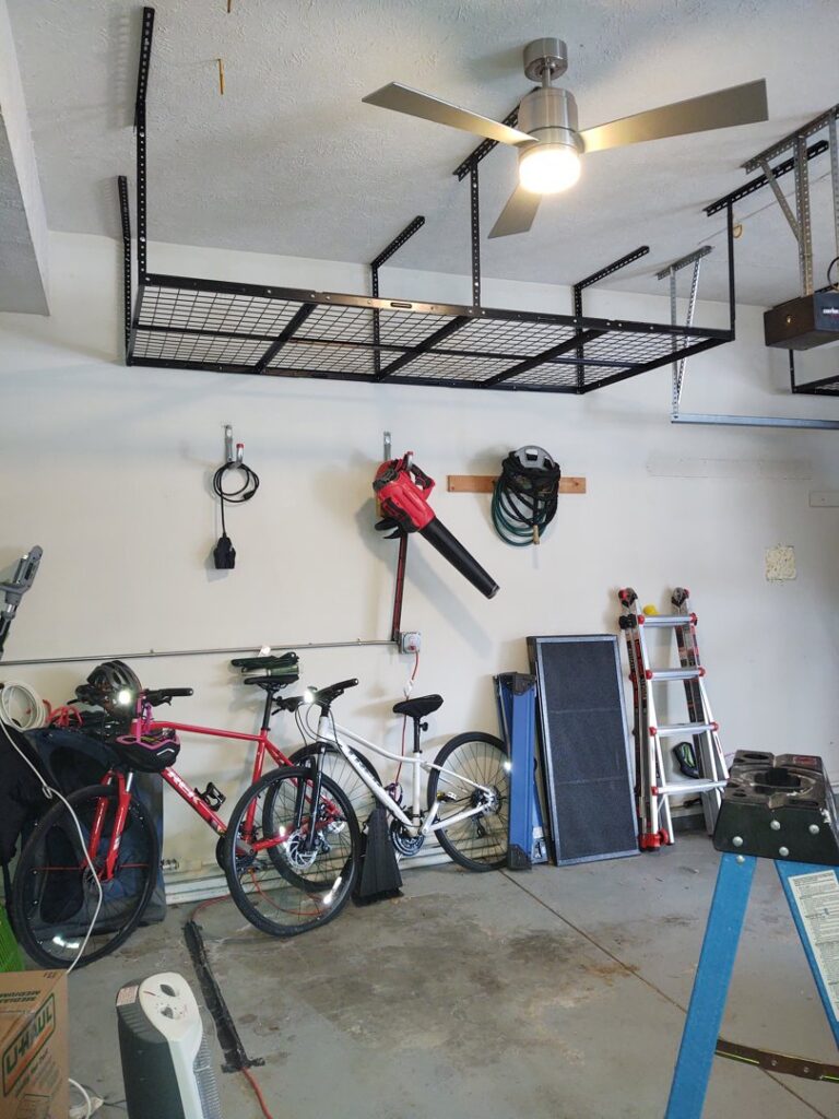 A newly installed overhead storage rack in a garage, a service offered by IFixdIt Handyman Services in Omaha, NE.