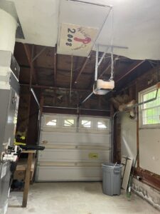 A garage interior undergoing renovation with exposed studs and insulation by Castle Drywall & Plaster in Chesapeake, VA.