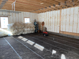 Spray foam insulation installed on the walls and ceiling of a garage or large room by Spray Foam Solutions Of Erie in Erie, PA.