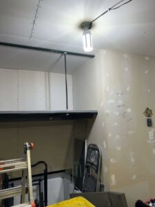 A garage or utility space showing shelving and drywall work in progress by Hawk Handyman Services in West Fargo, ND
