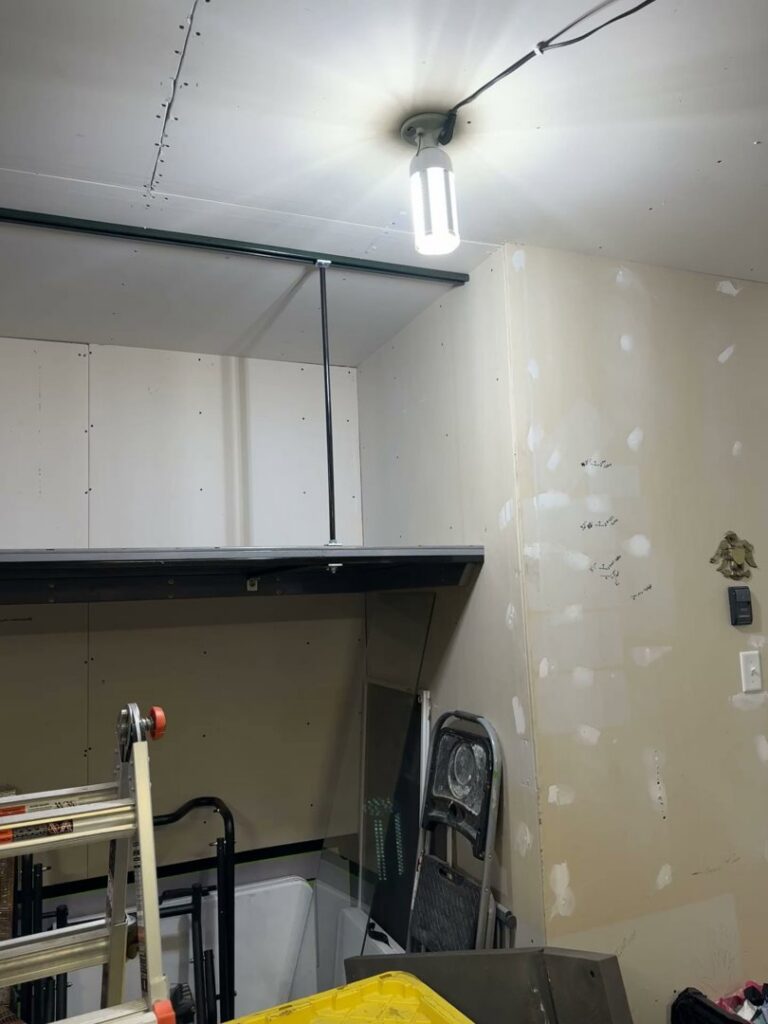 A garage or utility space showing shelving and drywall work in progress by Hawk Handyman Services in West Fargo, ND