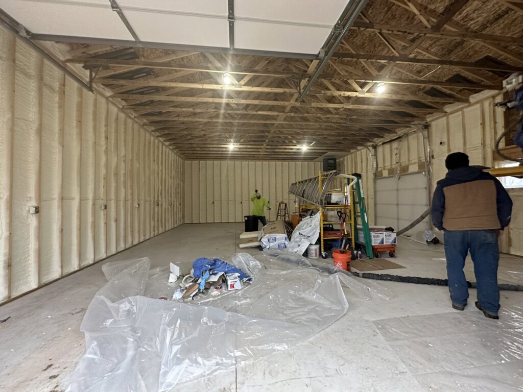 Interior of a garage with newly applied spray foam insulation on the walls and ceiling by Metro Insulation in Rockford, IL.