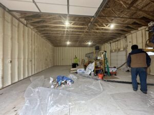 Interior of a garage with newly applied spray foam insulation on the walls and ceiling by Metro Insulation in Rockford, IL.