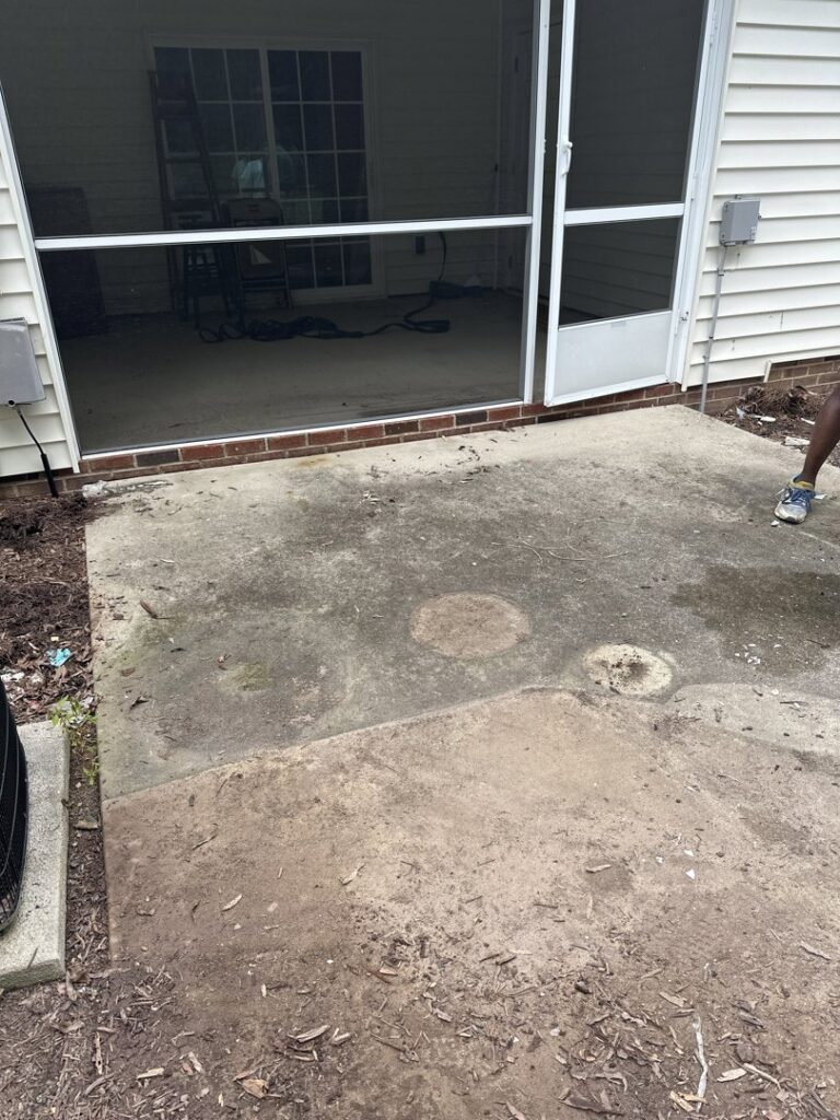 A residential garage with black trash bags and cardboard boxes ready for junk removal by Dumpzilla in Raleigh, NC.