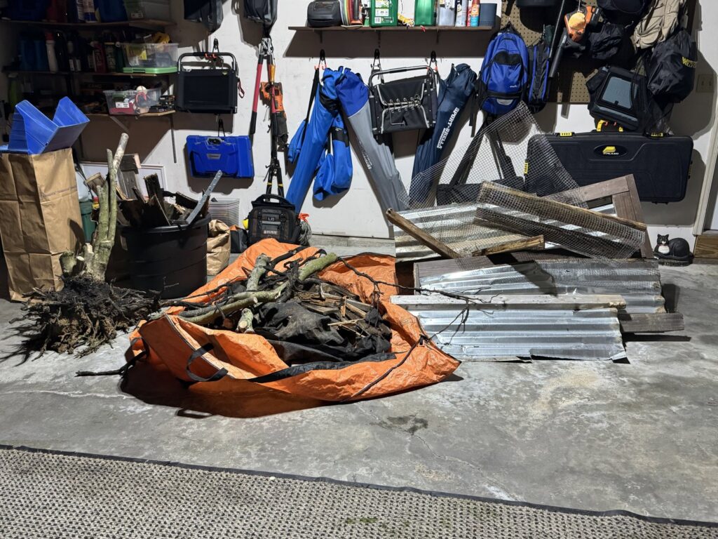 A garage containing yard waste, branches, and metal sheets, ready for junk removal by You Call We Haul Junk Removal in Milwaukee, WI.