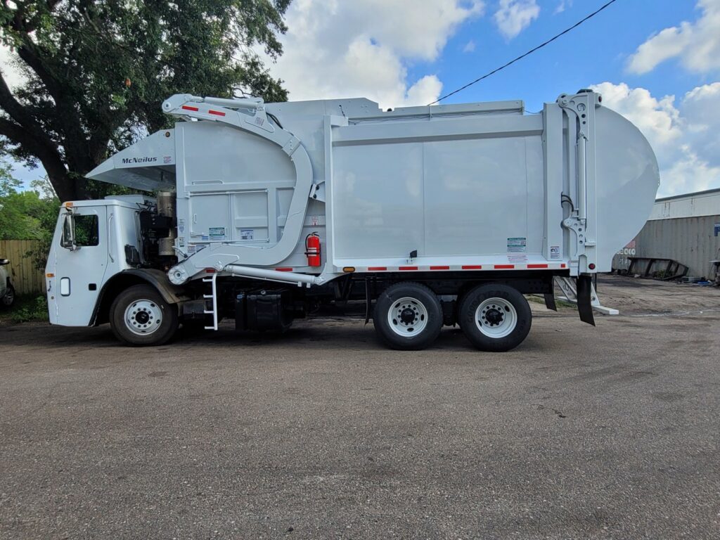 A clean white garbage truck used by Community Disposal for waste collection services in Jacksonville, FL.