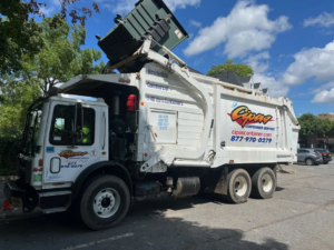 A J.Cipas Container Service garbage truck picking up a dumpster for junk removal in South Plainfield, NJ.