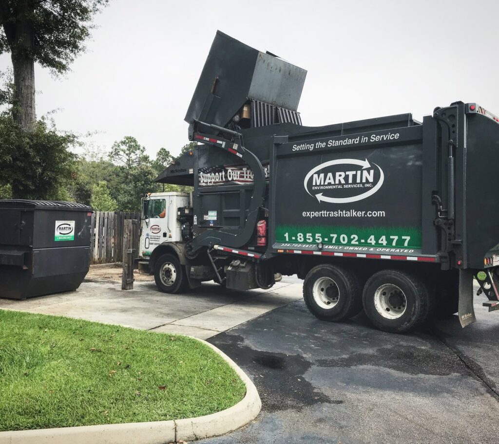 A Martin Environmental garbage truck emptying a large commercial dumpster in Dothan, AL.