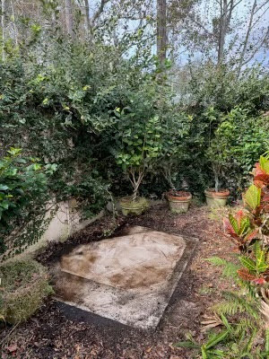 A garden area cleared of an old hot tub, showcasing the completed junk removal service by Route Junk in Orlando, FL.