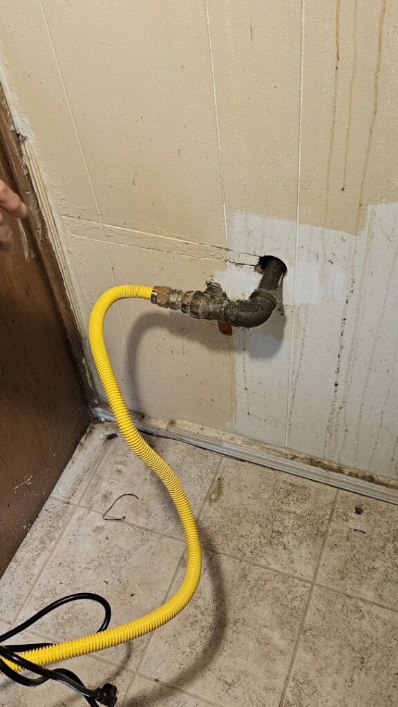 A yellow flexible gas line connected to a pipe, indicating gas line installation or repair by Clear Flow Plumbing, Heating, and Hvac Contractors LLC in Jersey City, NJ