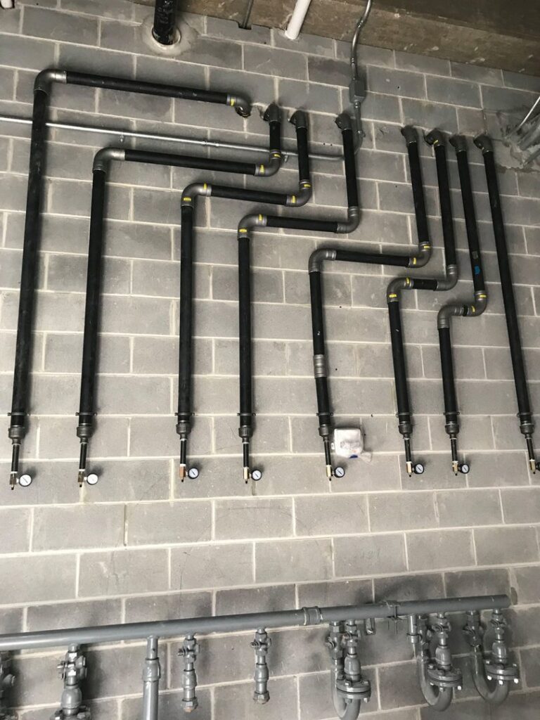 Gas pipe installation on a brick wall by Snyder Solutions LLC, offering gas services in Richmond, VA