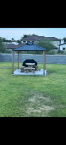 A newly installed gazebo on a concrete slab in a backyard by Camacho's Construction LLC in Laredo, TX.