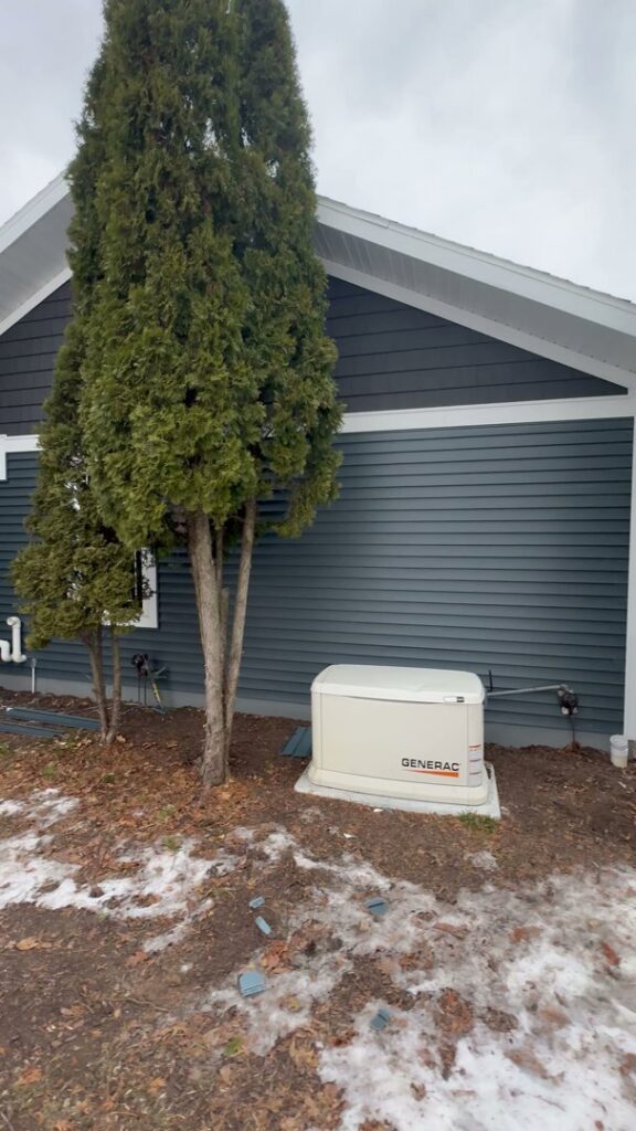 A Generac home standby generator professionally installed next to a house by L12 Construction LLC in Oshkosh, WI.