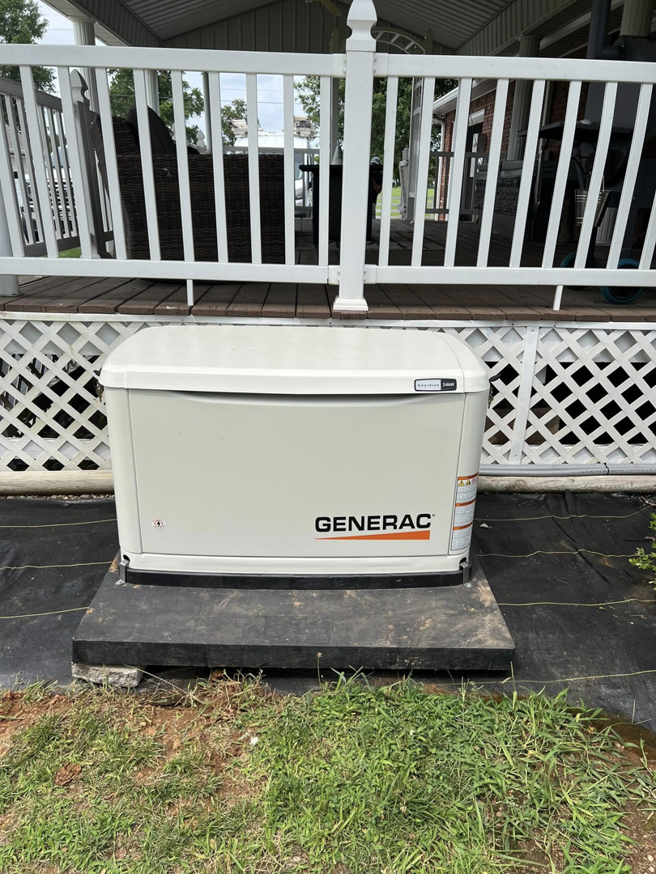 A Generac whole-house generator installed next to a residential porch by Morris Electrical Service in Hopkinsville, KY.