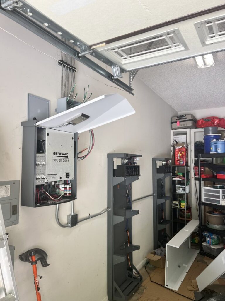 A Generac Power Core system and electrical panels installed in a garage by Specialty Service Group in Knoxville, TN.