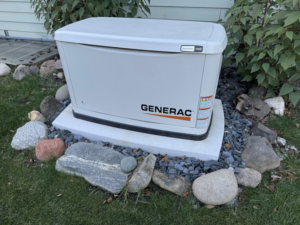 A Generac standby generator professionally installed on a concrete pad by Island Time Construction LLC in Saint Francis, WI.