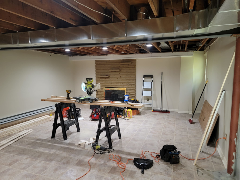 A general contractor project in progress showing a miter saw and fireplace by Jake Fortin Carpentry Services in Pittsburgh, PA.