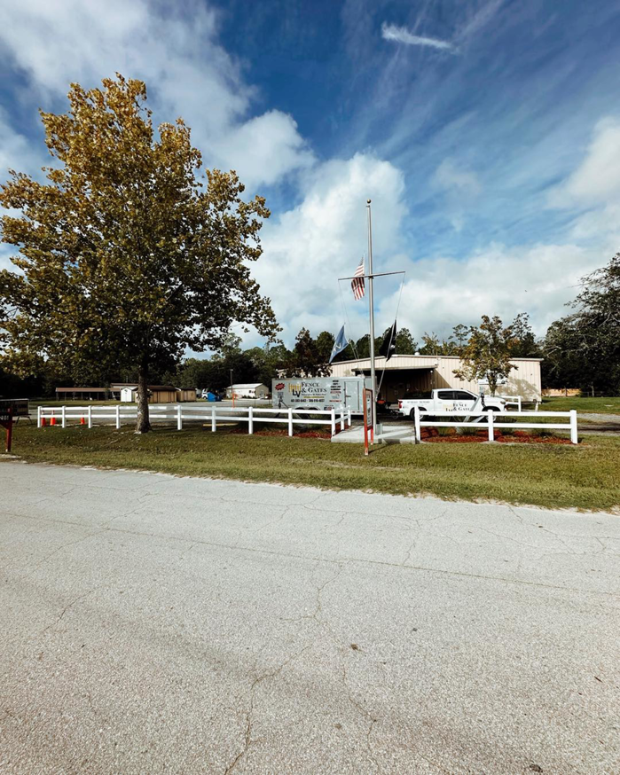 A general contractor project showing a long white fence installation by LV Fence and Gates in Jacksonville, FL.