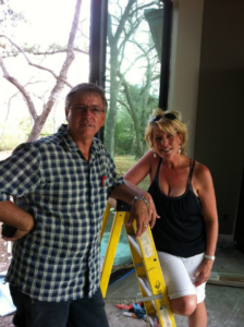 General contractors standing on a residential construction site with a ladder for Enertech Builders in Austin, TX.