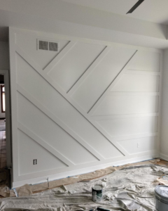 An interior room undergoing renovation with a geometric accent wall installation by UpGray'D Remodeling LLC in Chicago, IL.