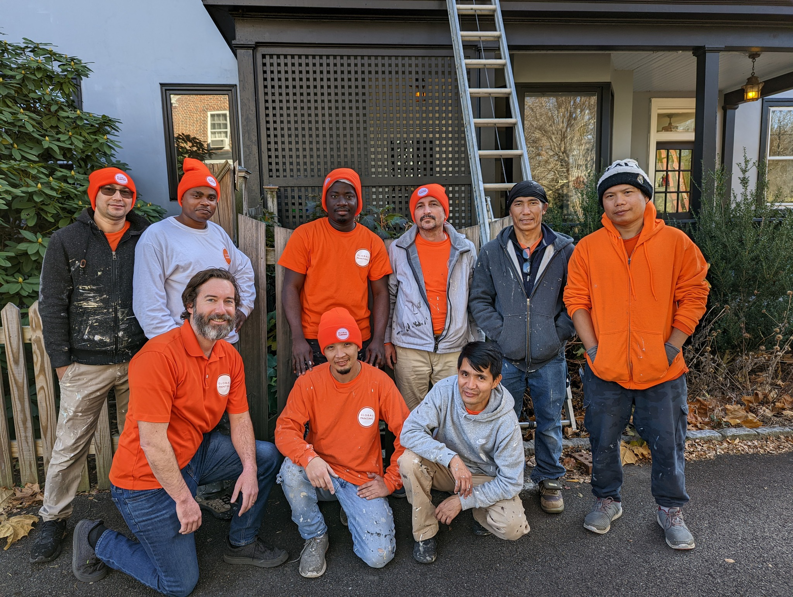 The Global Painting RVA crew posing with a ladder in front of a house after completing an exterior painting job in Richmond, VA.