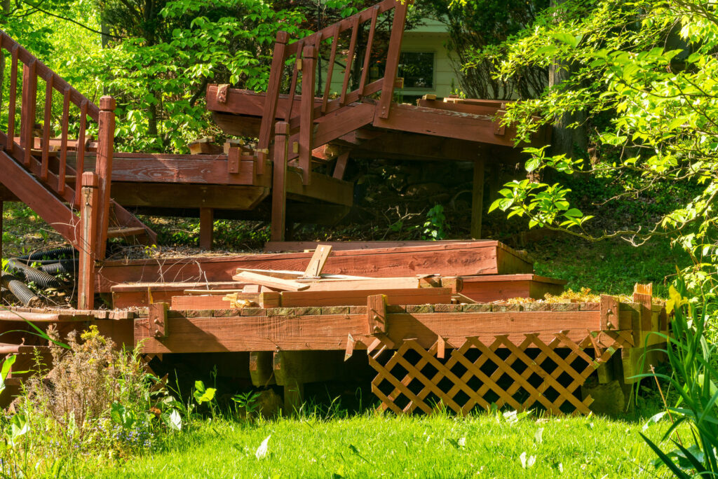 A GM Junk Removal employee moving a large sofa out of a home during a junk removal service in Frederick, MD.