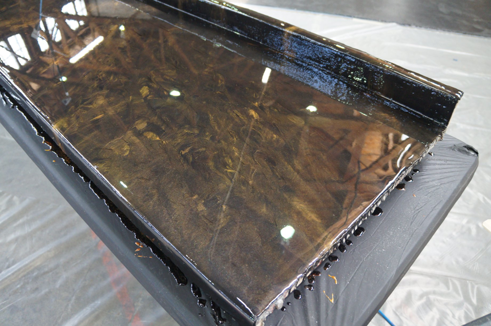 A close-up of a gold and black swirled epoxy resin surface completed by Forte Painting Company in Boulder, CO.