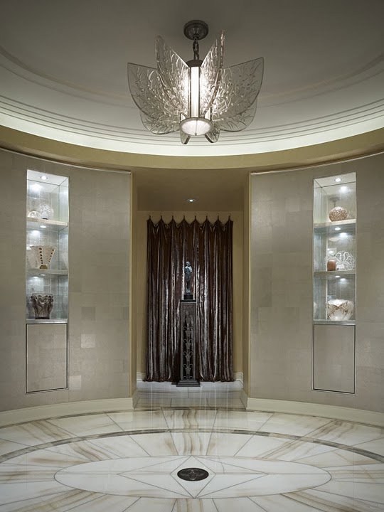 A grand foyer interior renovation with a circular marble floor and custom lighting by S.N. Peck Builder, Inc. in Chicago, IL.