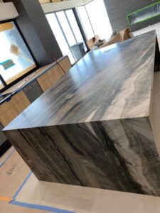 A professional reception desk featuring a polished granite countertop installed by Oddonetto Granite & Marble LLC in Phoenix, AZ.