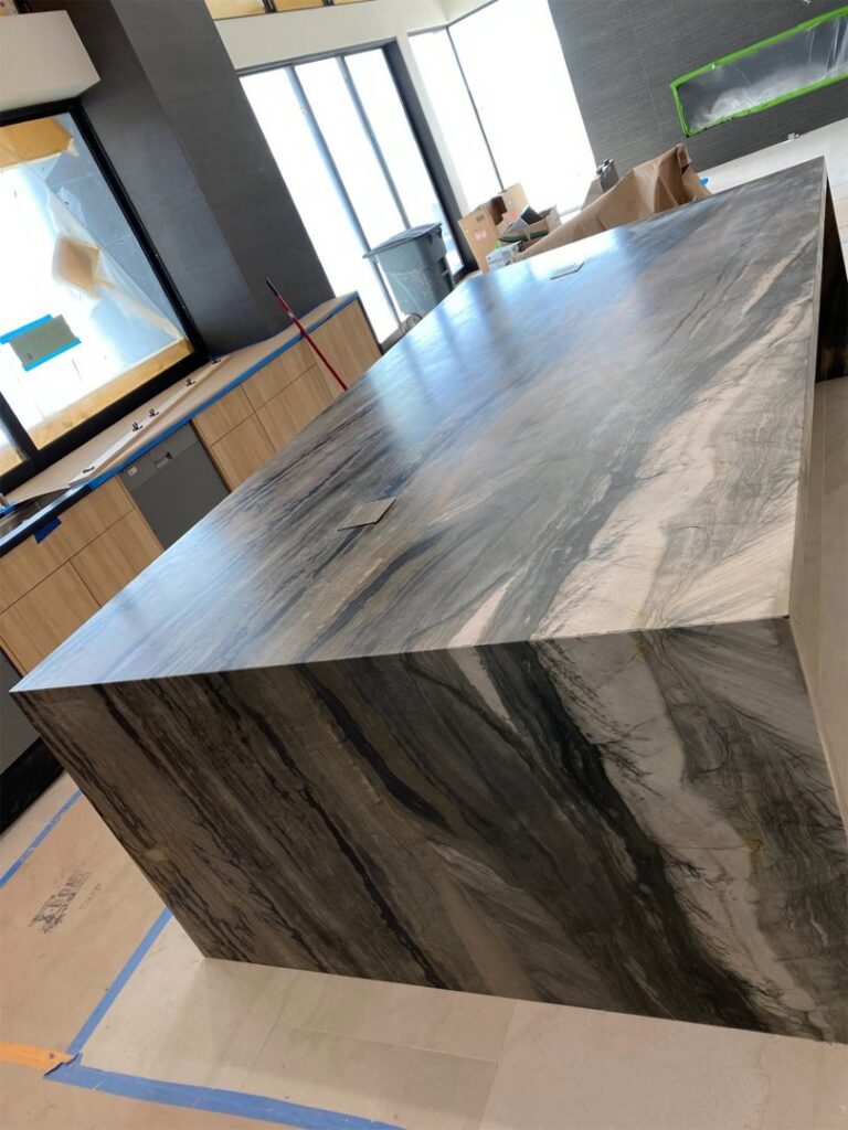 A professional reception desk featuring a polished granite countertop installed by Oddonetto Granite & Marble LLC in Phoenix, AZ.